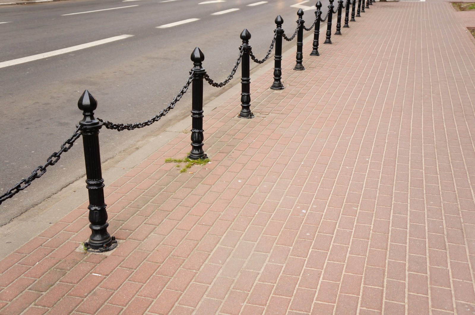 Beautiful shot of a sidewalk made of red stones with black modern security metal poles - Road Work Sifu Ancillary & Supporting Works | Infrastructure & Earth Works | Kontraktor Jalan Raya Berpengalaman | Kontraktor Jalan Raya Klang Valley | Road Furniture Installation | Road Pavement Works | Servis Kerja Jalan Raya | Sewa Jentera Klang Valley | roadwork contractor klang valley | kontraktor kerja jalan raya selangor | Kontraktor Jalan Raya | Kerja Jalan Raya & Road Pavement | Roadcap Asphalt Overlay | Kerja Infrastruktur & Earth Works | Road Furniture Installation | Kontraktor Jalan Raya Malaysia