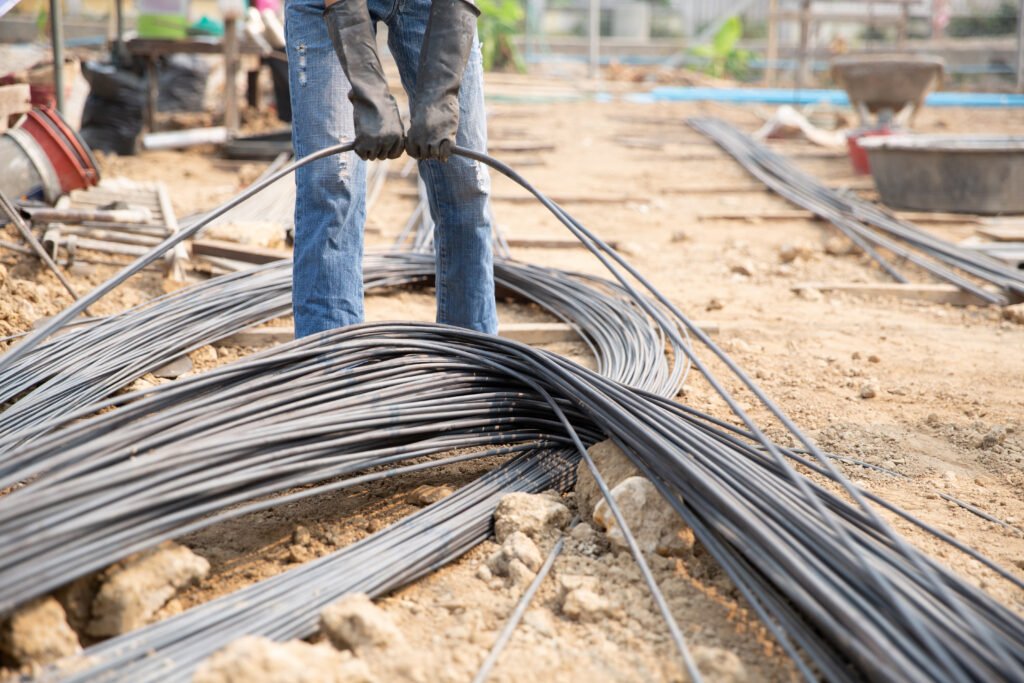A group of steel rod tight by chain and lift up at construction - Road Work Sifu Ancillary & Supporting Works | Infrastructure & Earth Works | Kontraktor Jalan Raya Berpengalaman | Kontraktor Jalan Raya Klang Valley | Road Furniture Installation | Road Pavement Works | Servis Kerja Jalan Raya | Sewa Jentera Klang Valley | roadwork contractor klang valley | kontraktor kerja jalan raya selangor | Kontraktor Jalan Raya | Kerja Jalan Raya & Road Pavement | Roadcap Asphalt Overlay | Kerja Infrastruktur & Earth Works | Road Furniture Installation | Kontraktor Jalan Raya Malaysia